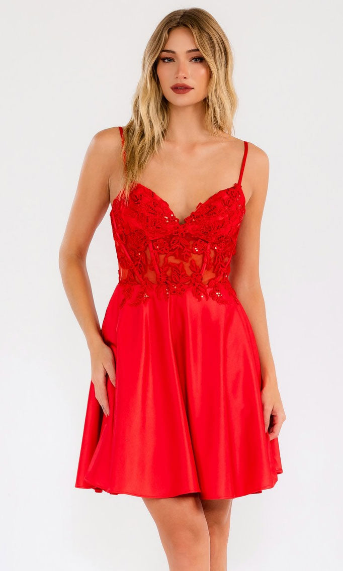 Woman in the Sheer-Waist Short A-Line Hoco Dress: Juliet JT940R, featuring a red sequin-embroidered bodice and flared satin skirt, standing against a plain light background.